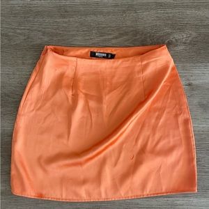Orange satin mini skirt